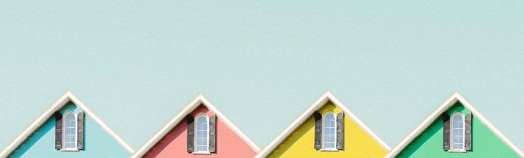 Aesthetic view of vibrant house roofs under a clear turquoise sky in Buffalo, NY.